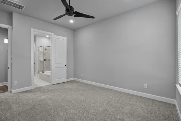 an empty room with chandelier fan