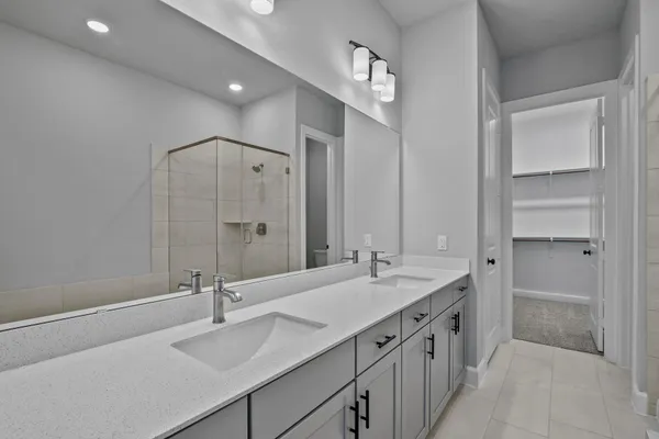 a bathroom with a double vanity sink and mirror