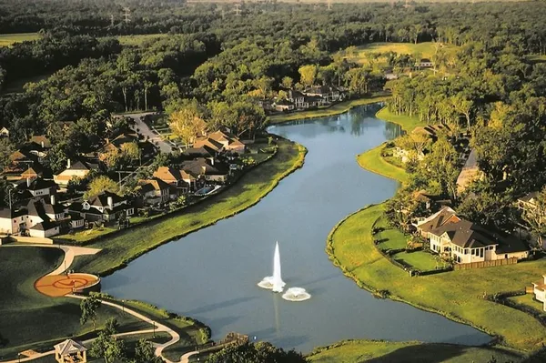 an aerial view of a house with a swimming pool