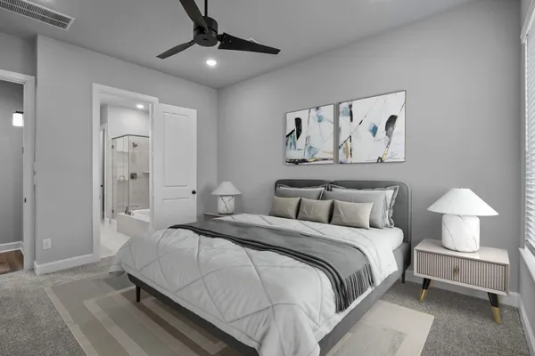 a bedroom with a large bed and a lamp