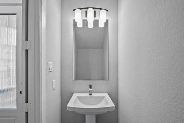 a bathroom with a sink and a mirror