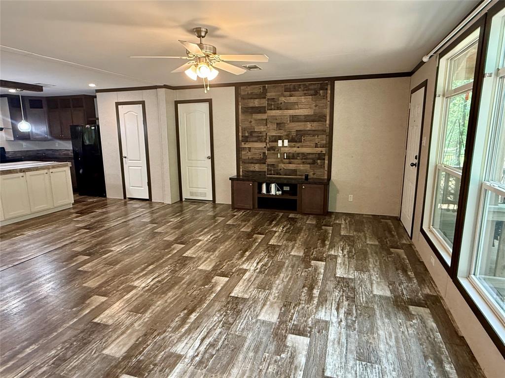 145 Adalida Lane Springtown, TX 76082 - Photo 5 of 29 Spacious living area featuring wood-finish flooring and a ceiling fan