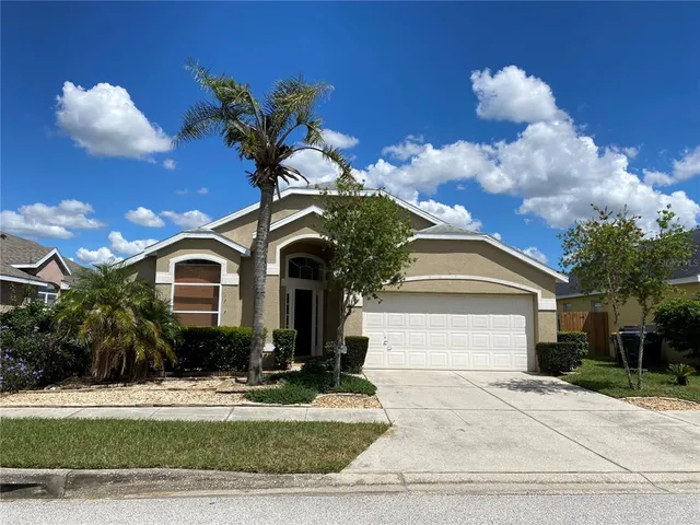 a front view of a house with a yard and a garage