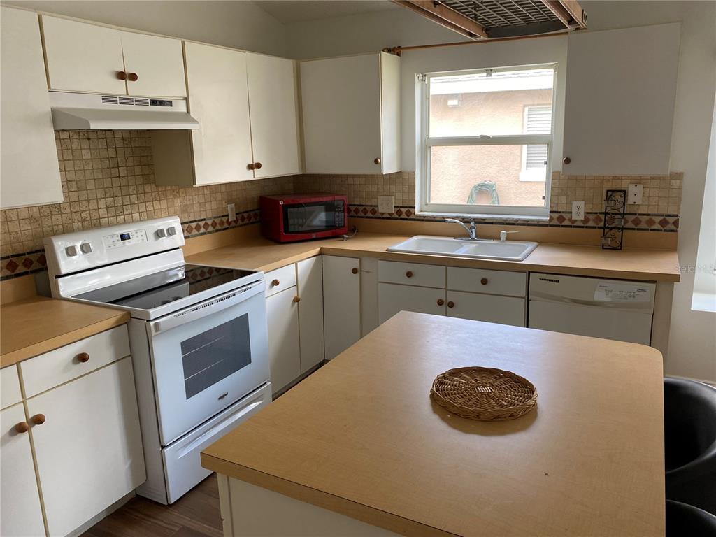 635 Rochester Loop Davenport, FL 33897 - Photo 18 of 22 a kitchen with a sink a stove and cabinets