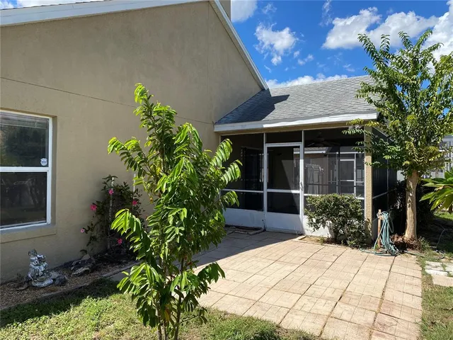 a house with potted plants in front of it