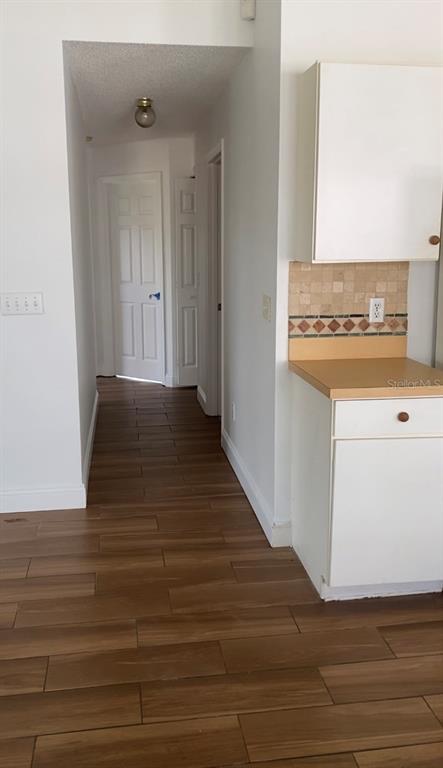 635 Rochester Loop Davenport, FL 33897 - Photo 10 of 22 a view of an empty room with wooden floor