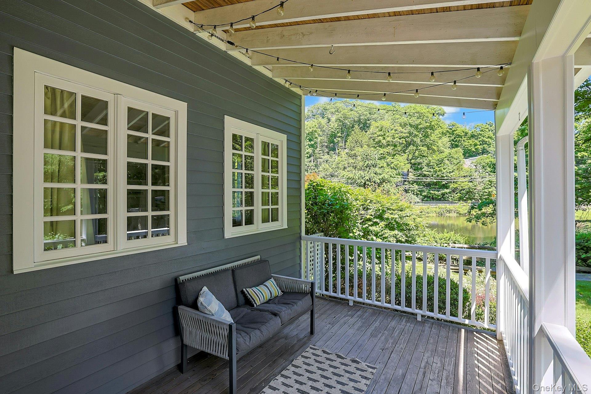 65 Douglas Road Chappaqua, NY 10514 - Photo 4 of 41 Morning coffee, evening wine, and a peaceful pond view in every season. This inviting porch offers the perfect place to relax, unwind, and take in the natural beauty of the property.