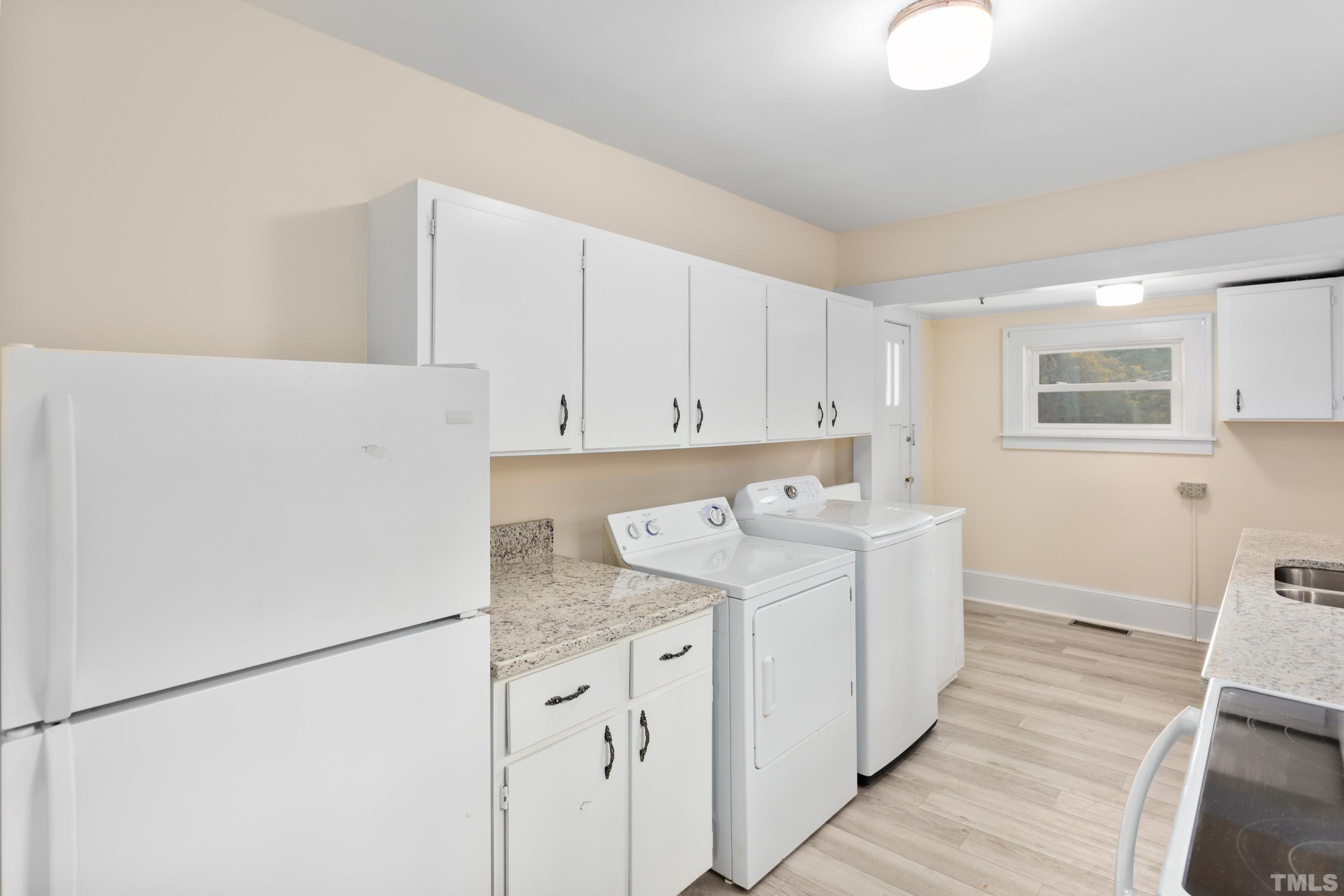 111 Turner Street Raleigh, NC 27607 - Photo 13 of 26 a utility room with cabinets washer and dryer