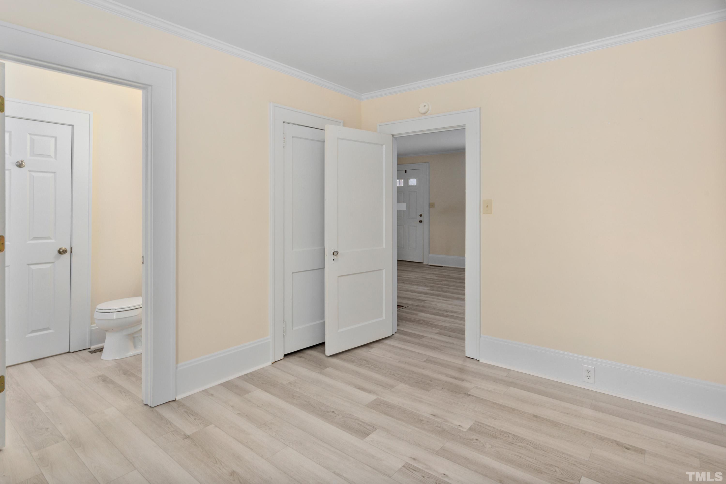 111 Turner Street Raleigh, NC 27607 - Photo 20 of 26 a view of a livingroom with wooden floor and a bathroom
