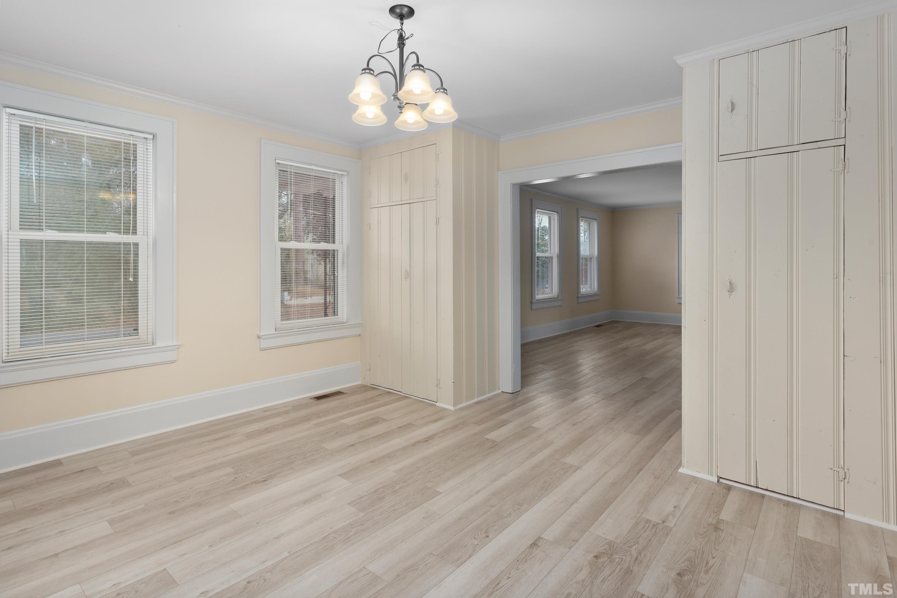 111 Turner Street Raleigh, NC 27607 - Photo 10 of 26 wooden floor in an empty room with a window