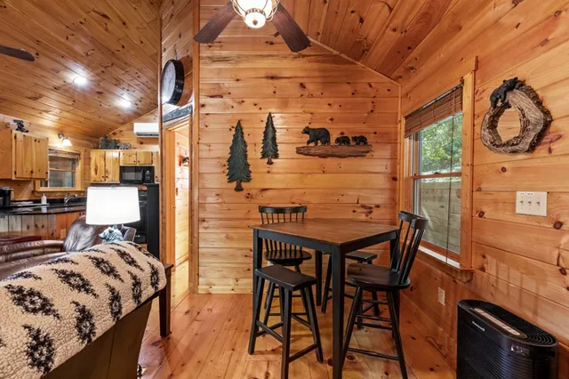 a living room with furniture a wooden floor and a large window