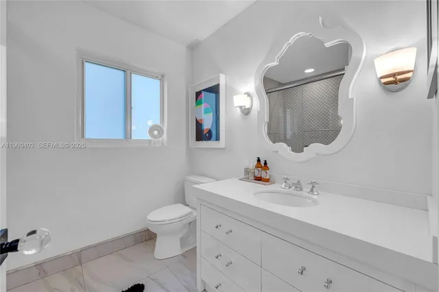 a bedroom with a bed and glass wall