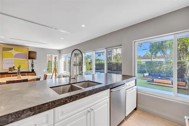 a kitchen that has a sink and a stove