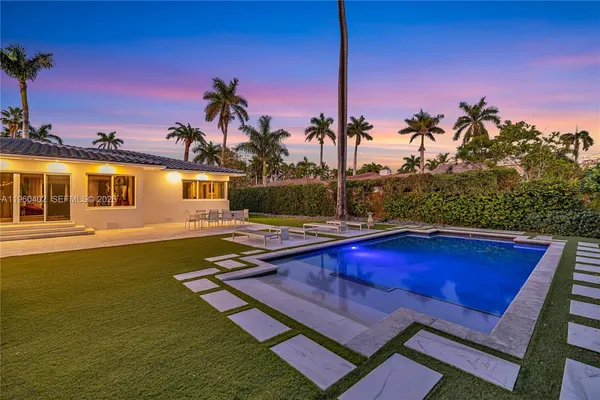 a view of a house with swimming pool and porch with furniture