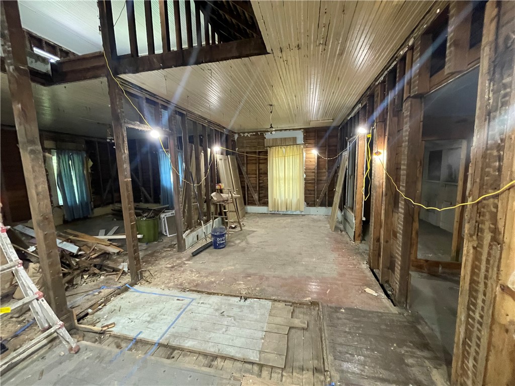 171 River Ridge Road Seneca, SC 29672 - Photo 4 of 22 An interior space undergoing renovation reveals exposed framing and original wood ceilings, awaiting a transformative refresh.