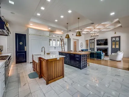a large kitchen with a table and chairs