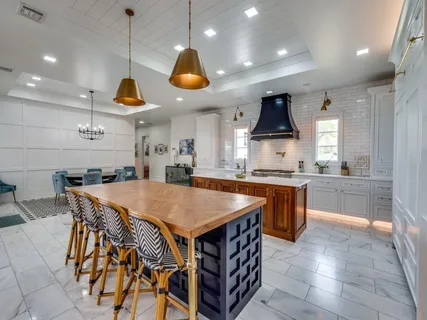 a kitchen with a table a sink and a stove