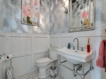 a bathroom with a sink mirror and toilet