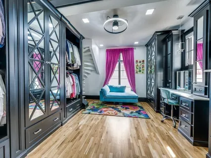 a bedroom with a bed and a dresser in it