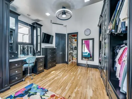 a living room with large furniture and a book shelf