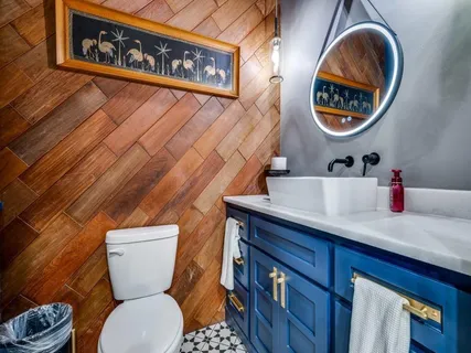 a spacious bedroom with a bed and a flat screen tv