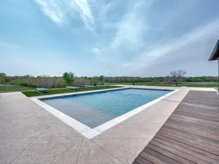 a view of swimming pool with outdoor space and seating area