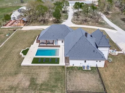 a aerial view of a house with swimming pool