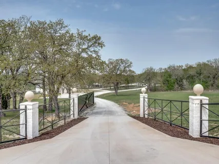 a view of a street with large trees