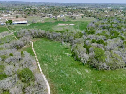 a view of a green field with lots of green space in the background