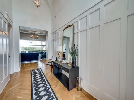 a hallway with wooden floor and furniture