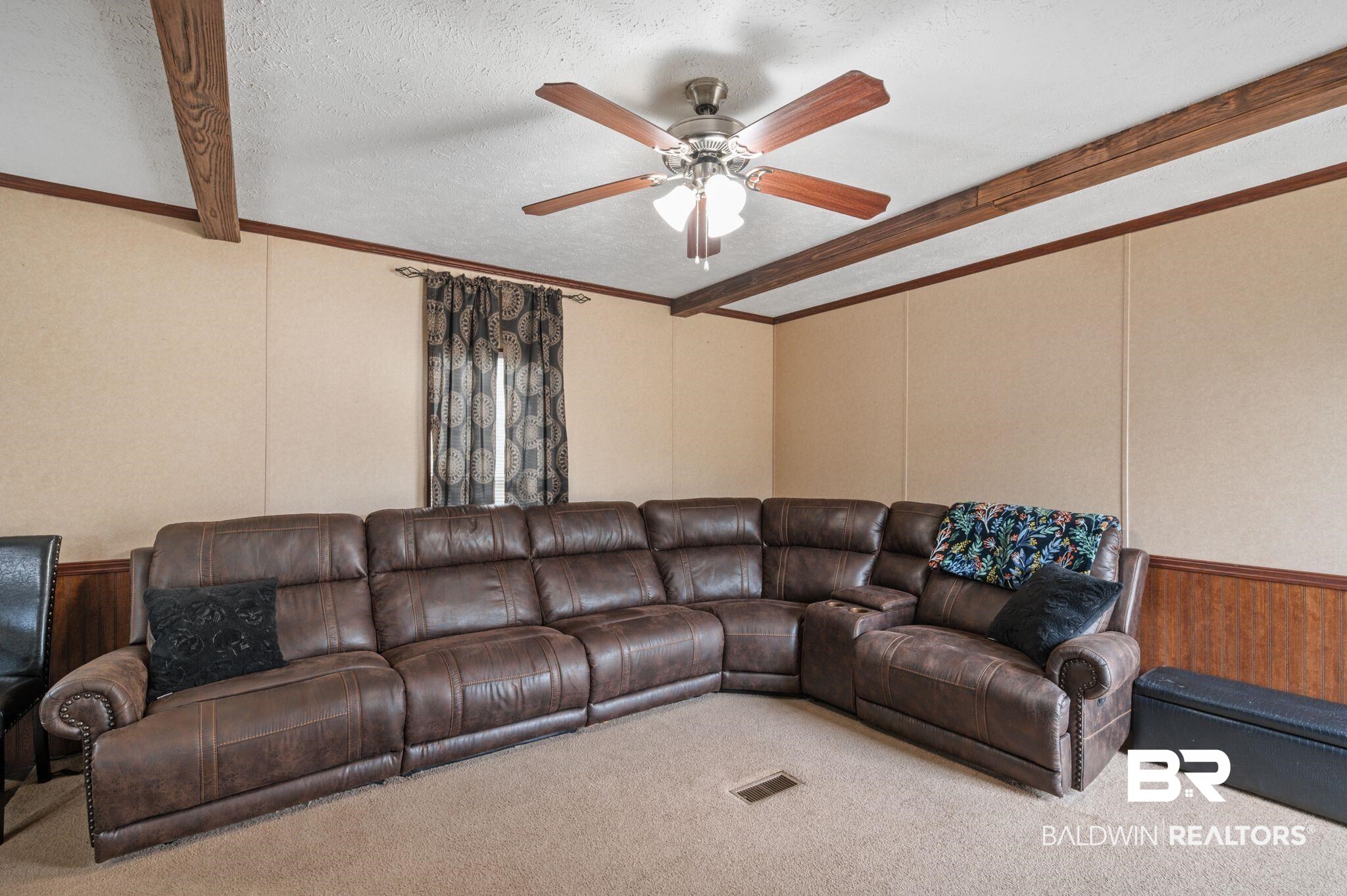 39908 T A Chastang Road Bay Minette, AL 36507 - Photo 4 of 20 Living room with carpet floors, visible vents, a decorative wall, a textured ceiling, and beamed ceiling
