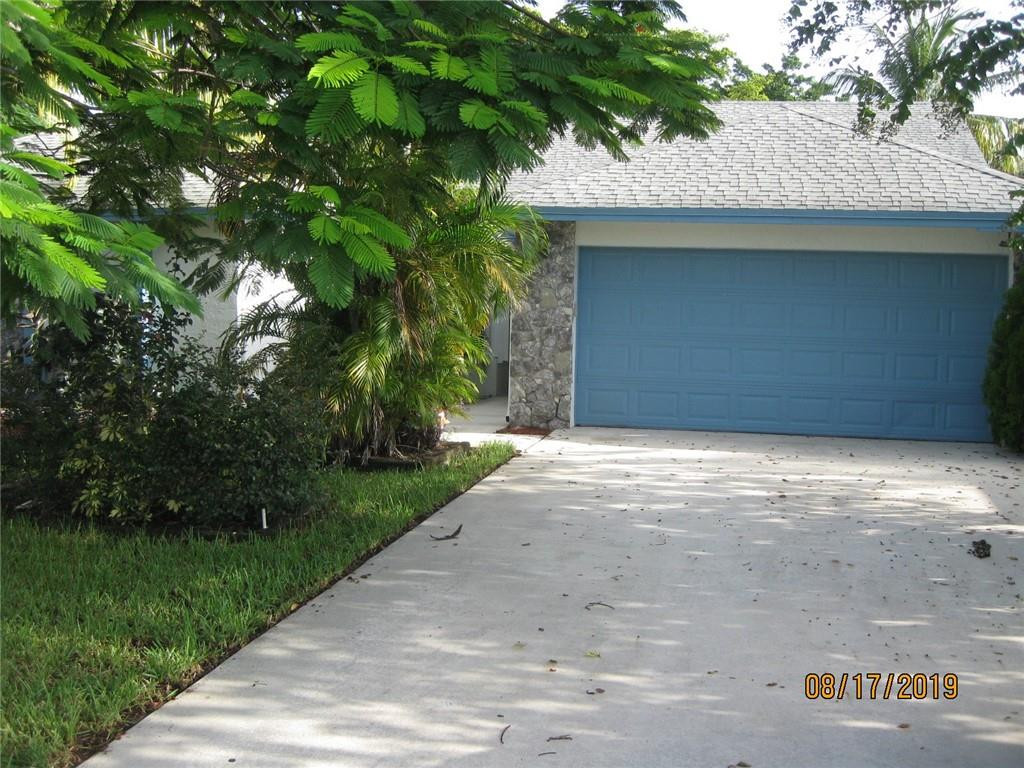 9629 Trivolo Place Boca Raton, FL 33434 - Photo 2 of 7 a house with a tree in front of it