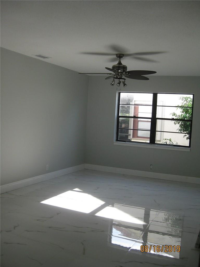9629 Trivolo Place Boca Raton, FL 33434 - Photo 4 of 7 a view of empty room with windows