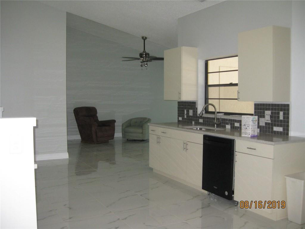 9629 Trivolo Place Boca Raton, FL 33434 - Photo 5 of 7 a kitchen with a sink cabinets and appliances