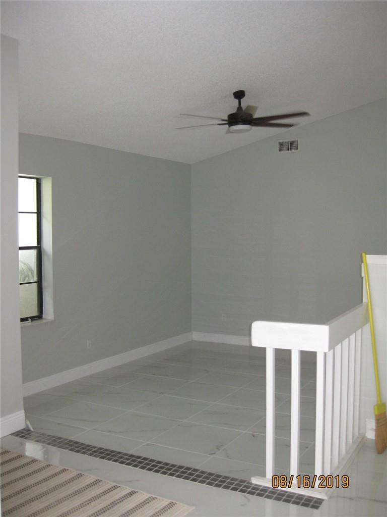 9629 Trivolo Place Boca Raton, FL 33434 - Photo 6 of 7 an empty room with windows