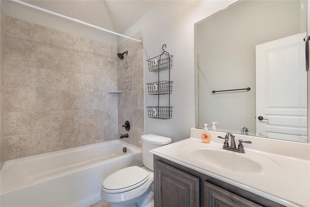 5116 Prospect Street McKinney, TX 75071 - Photo 18 of 23 a bathroom with a sink a toilet and a bathtub