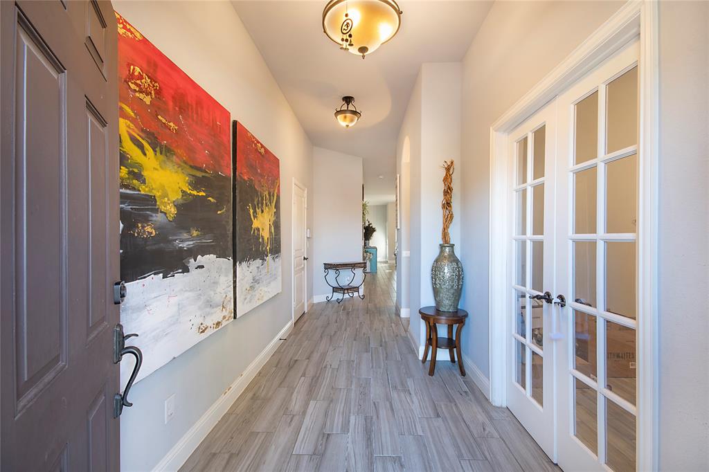 5116 Prospect Street McKinney, TX 75071 - Photo 2 of 23 a view of a hallway with wooden floor and livingroom with furniture
