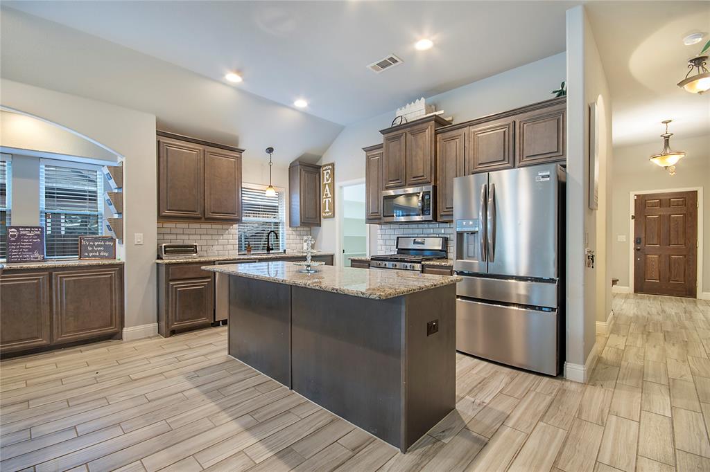 5116 Prospect Street McKinney, TX 75071 - Photo 5 of 23 a kitchen with stainless steel appliances a refrigerator sink and microwave