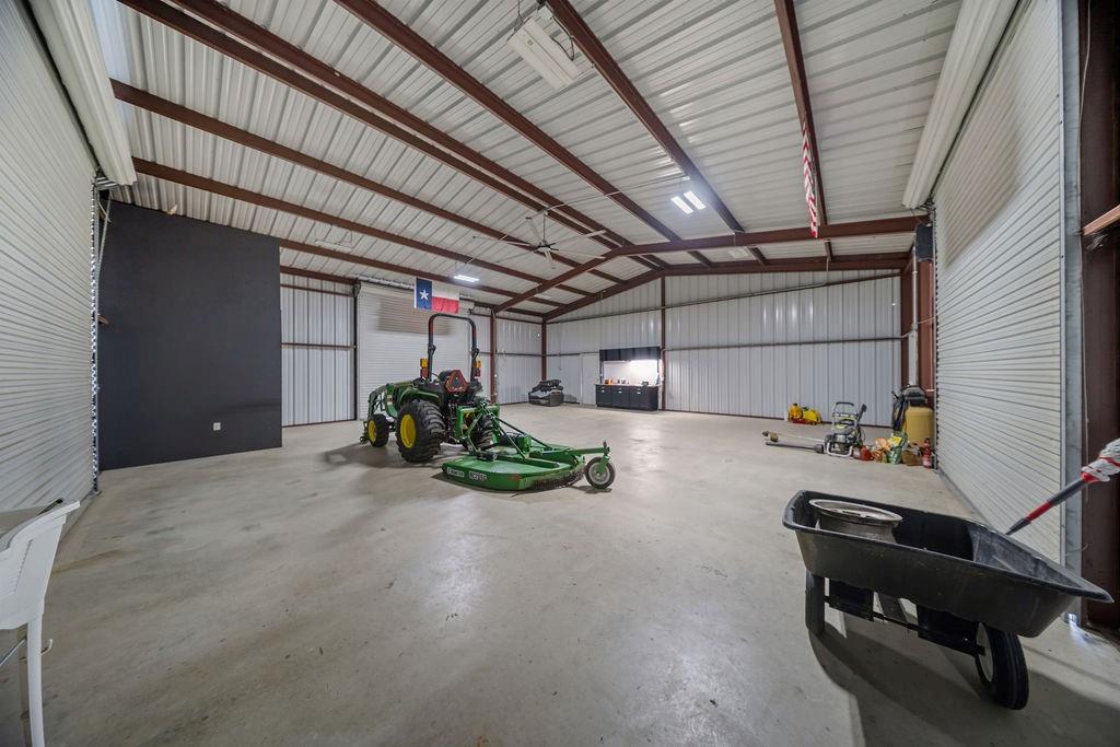 1161 Alsdorf Road Ennis, TX 75119 - Photo 25 of 28 Spacious interior featuring a concrete floor, exposed metal beam construction, and corrugated metal walls
