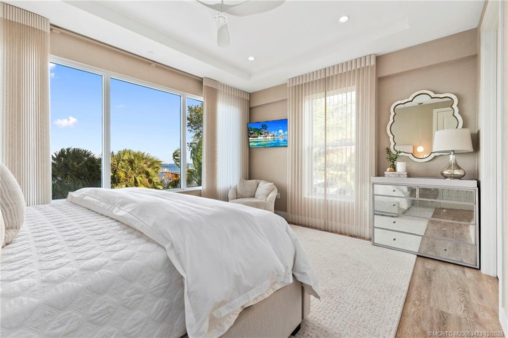 41 Southwest Seminole Street, Unit 206 Stuart, FL 34994 - Photo 36 of 79 a bedroom with a large bed and a dresser