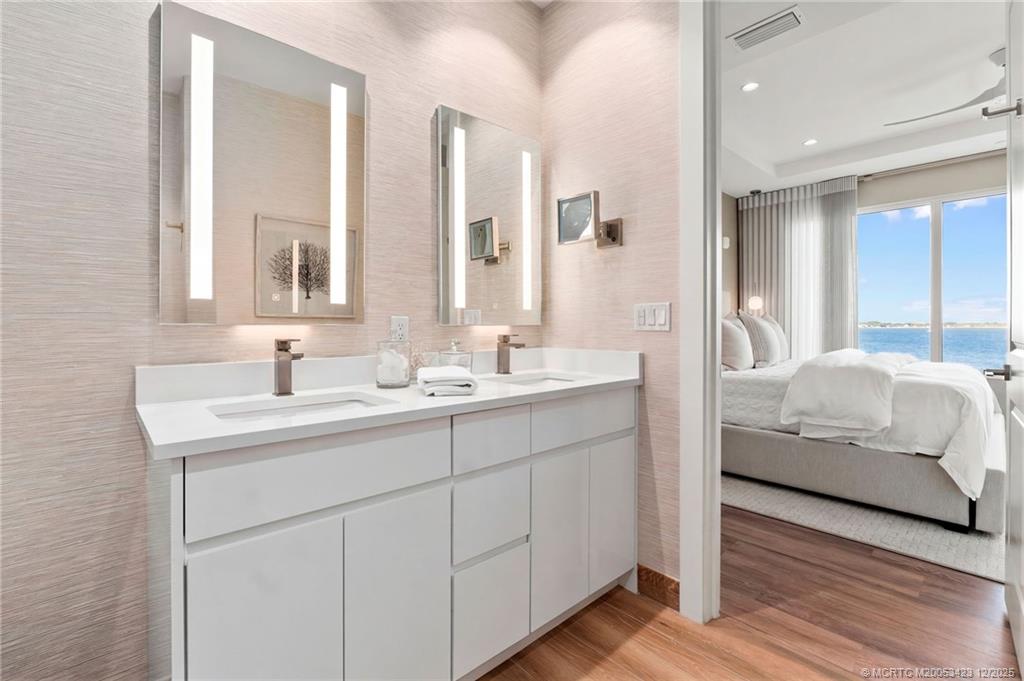 41 Southwest Seminole Street, Unit 206 Stuart, FL 34994 - Photo 41 of 79 a en suite bathroom with double sink and a mirror