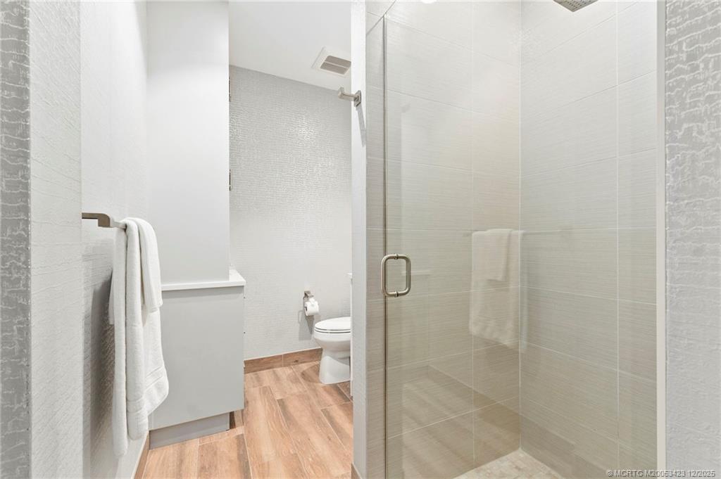 41 Southwest Seminole Street, Unit 206 Stuart, FL 34994 - Photo 46 of 79 a bathroom with a shower and toilet