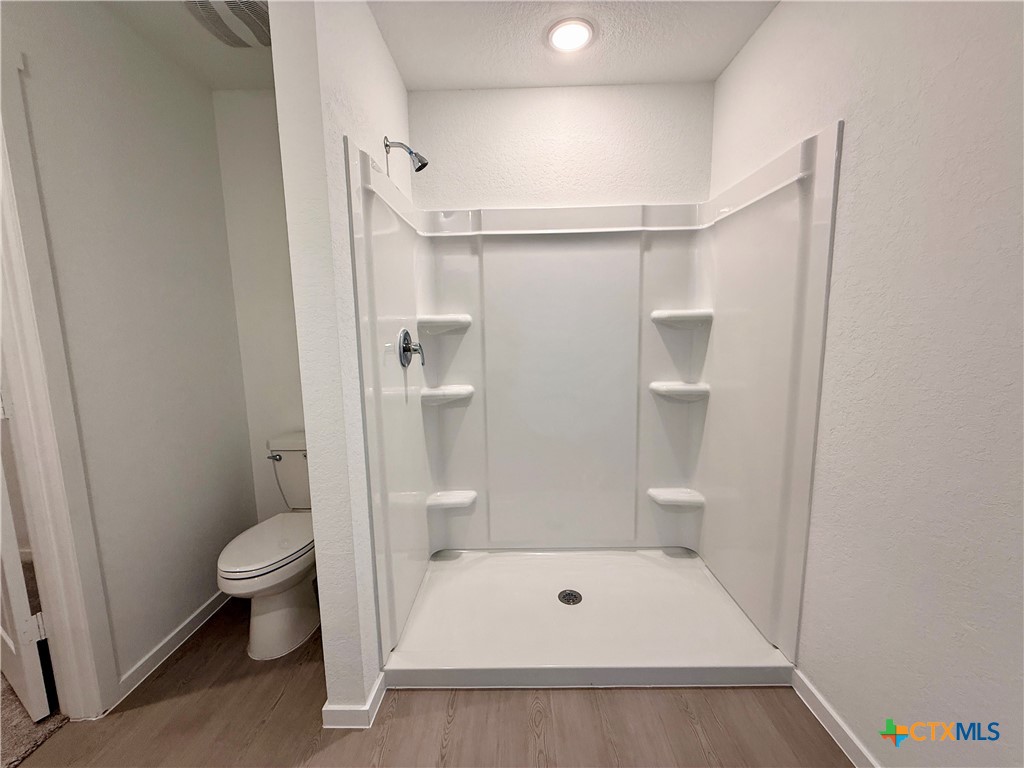 413 Moscato Road New Braunfels, TX 78130 - Photo 14 of 28 a bathroom with a shower and a toilet