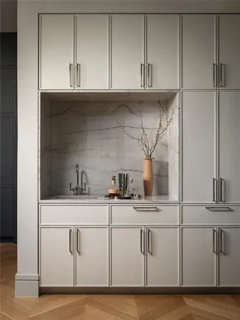 a kitchen with white cabinets and white appliances