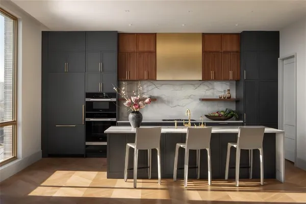 a kitchen with granite countertop a stove a sink and a refrigerator