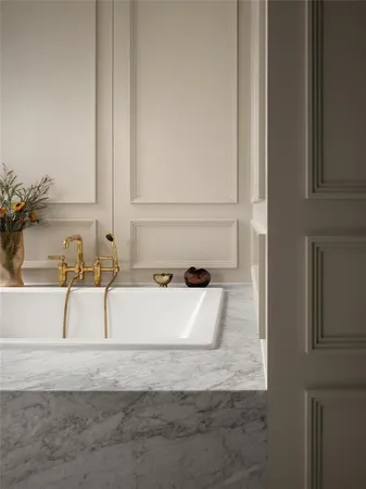 a bathroom with a tub sink and mirror