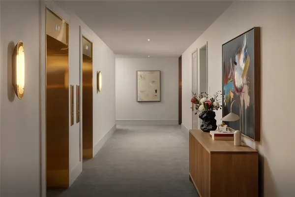 a view of a hallway with workspace and a window