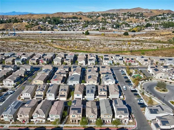 an aerial view of residential building with parking