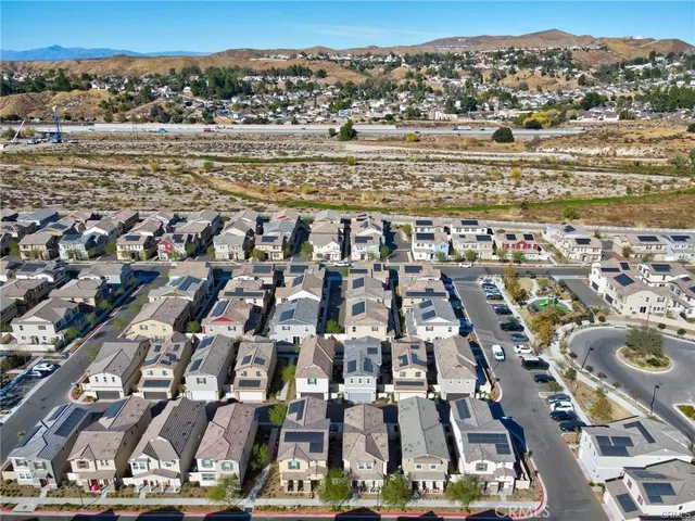 an aerial view of residential building with parking