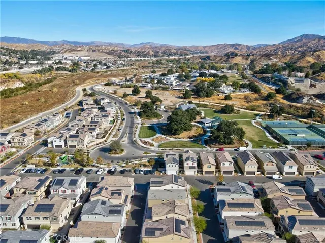 an aerial view of residential houses with outdoor space